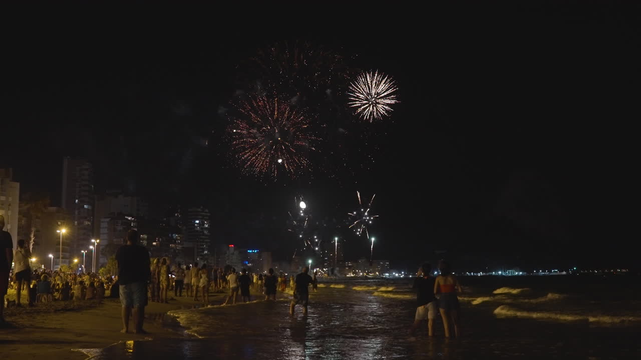 Fireworks over a beach at night
