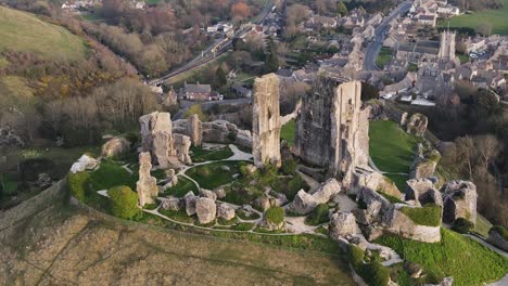 Aerial-top-down-orbiting-around-old-English-Corfe-Castle-perched-on-hill