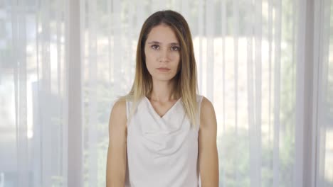 young woman looking calmly at camera.