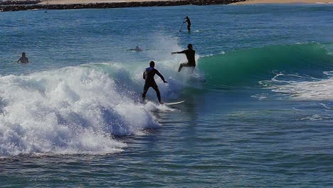 slow motion (120fps): male surfer surfing the wave  in barcelona, spain