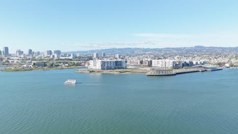 from the sky, oakland’s waterfront shows a patchwork of piers, rooftops, and gentle water movement.