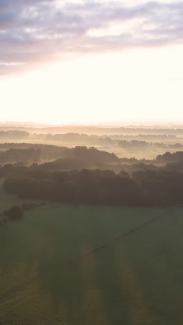 sunrise over misty countryside landscape