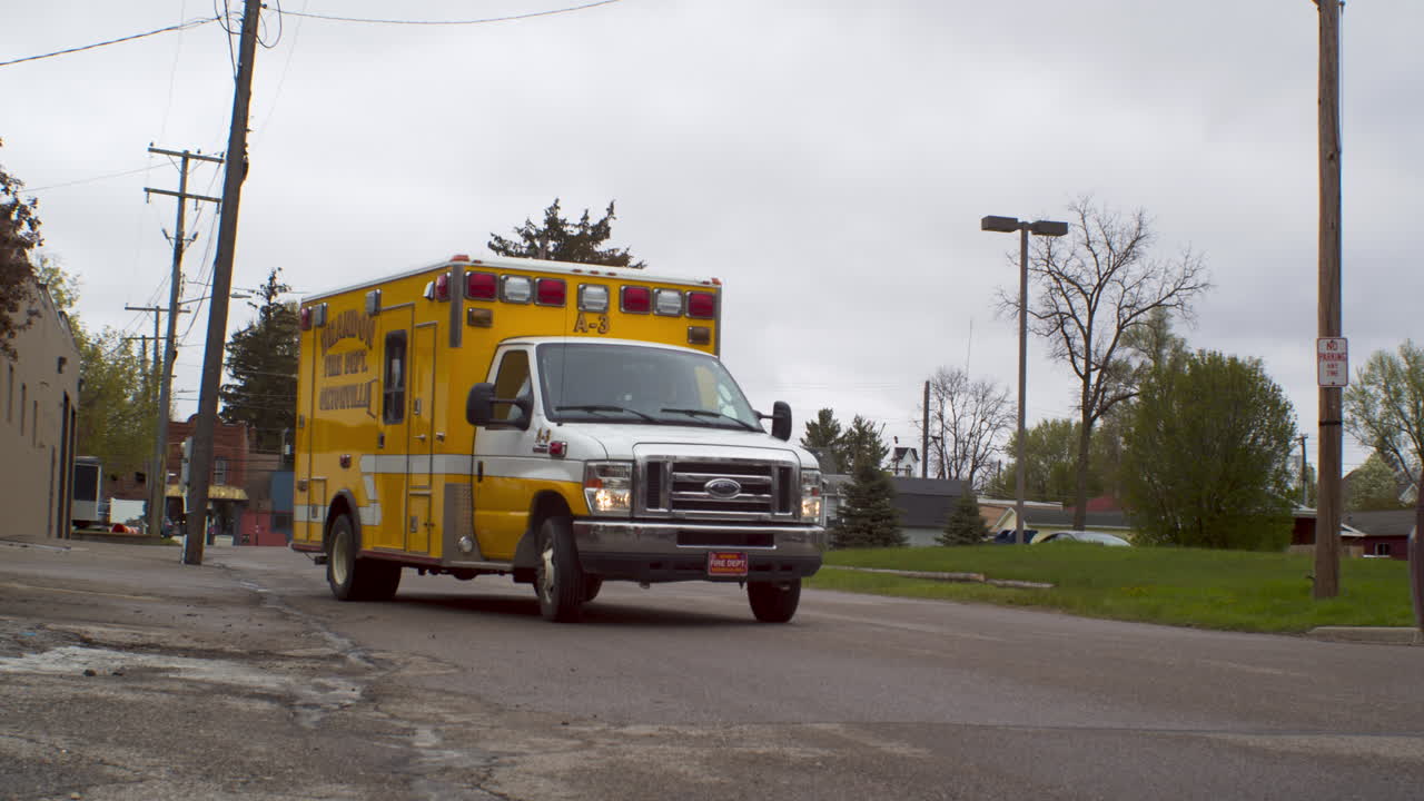 Ambulance in Ortonville Michigan driving down a road