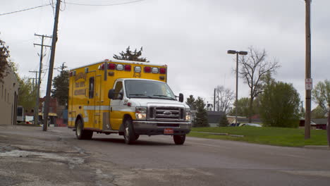 ambulance in ortonville michigan driving down a road