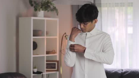 Young-man-gets-ready-for-office-business-job,-wearing-white-shirt,-static