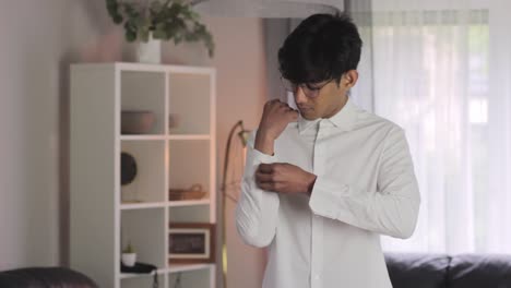 young man gets ready for office business job, wearing white shirt, static