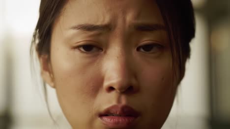 intense emotional close-up of a young woman reflecting deep concern and anxiety, capturing a moment of vulnerability and distress in a subtle context