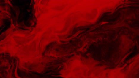 animation of vibrant coloured red liquid flowing in hypnotic motion on black background