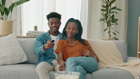 Black-couple,-laughing,-and-tv-play-fight-over