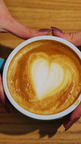 freshly made coffee from professional barista. barista serving cup of coffee on the bar to guest