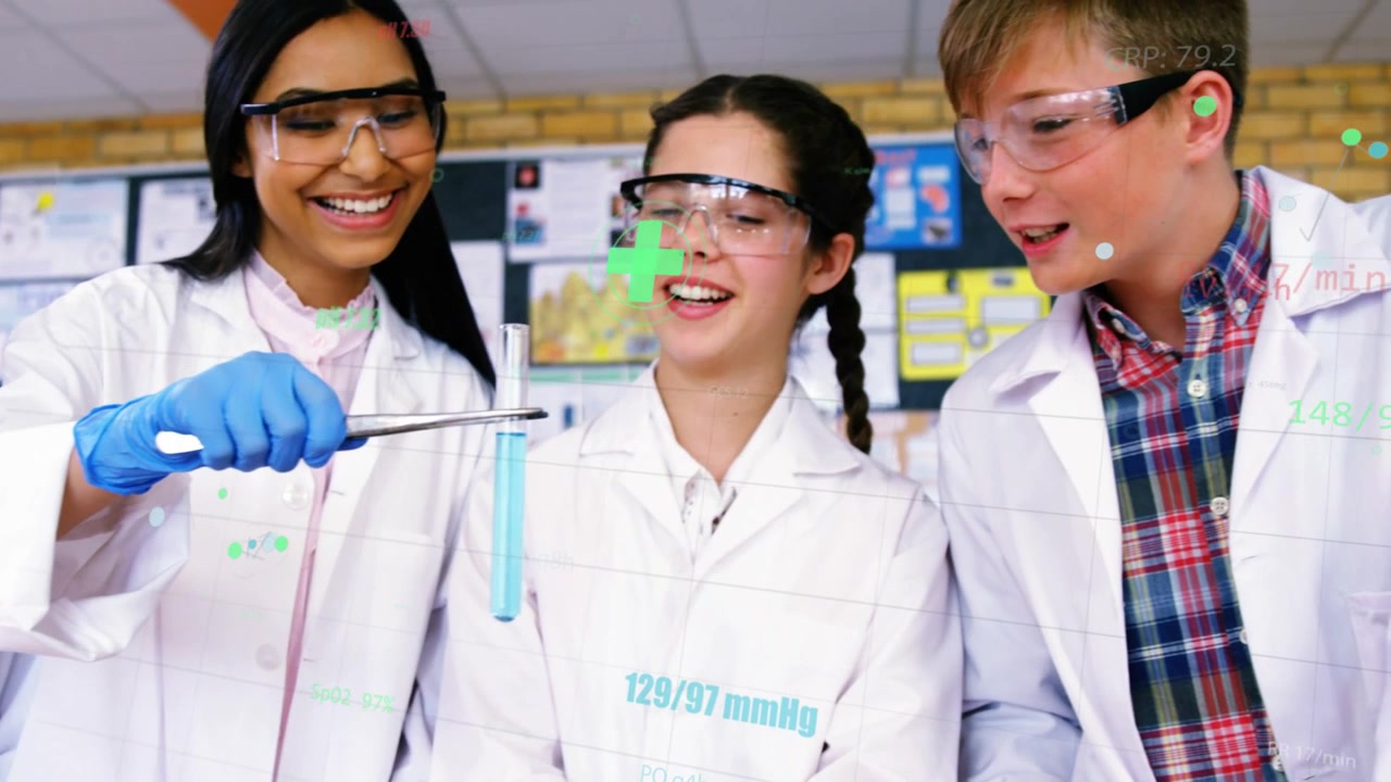 Studente con guanti che solleva una provetta contenente liquido blu, mentre i compagni si avvicinano e discutono la lezione di scienze.