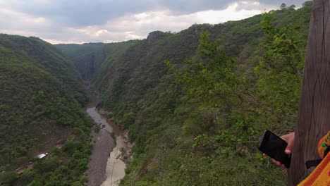 Latina-woman-enjoys-viewpoint-over-Somoto-Canyon-in-Nicaragua-jungle