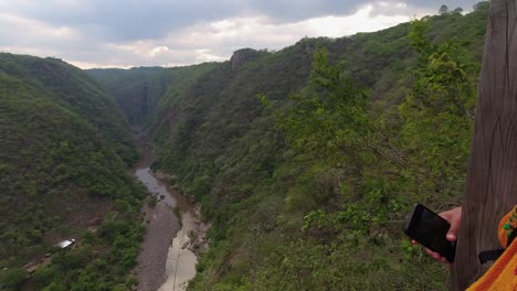 latina woman enjoys viewpoint over somoto canyon in nicaragua jungle