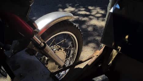 Wheel-of-Tricycle-on-Asphalt-Road