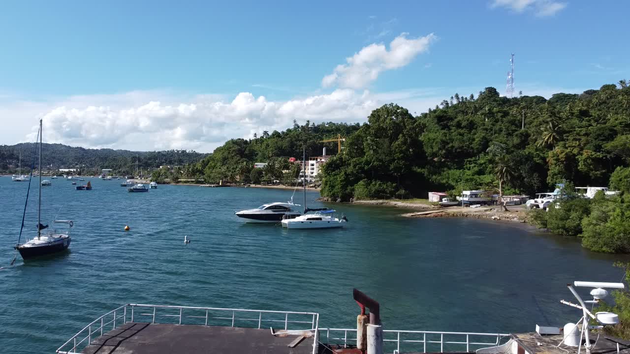 Aerial view of tropical beach, bay with boats and mountainous landscape, Samana Peninsula, Dominican Republic
