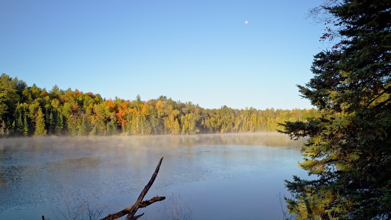 Cinematic wide landscape shot of the Au Sable River in morning mist