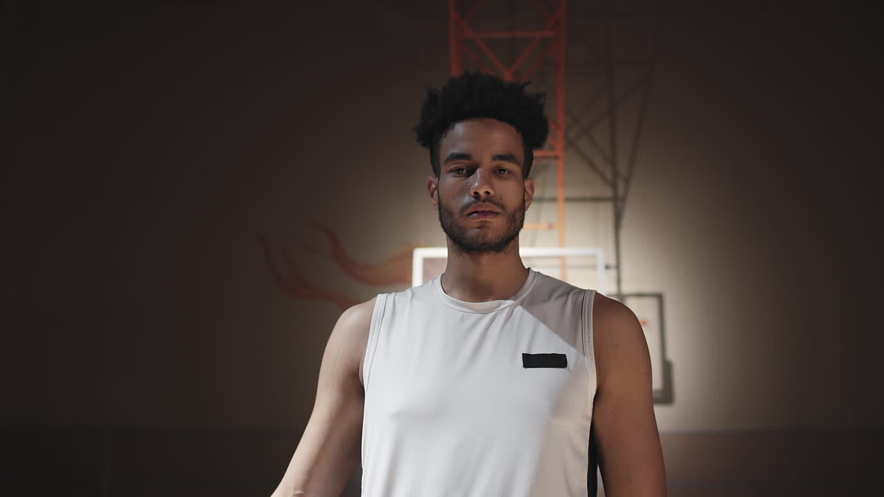 Portrait of Black Man on Dark Basketball Court