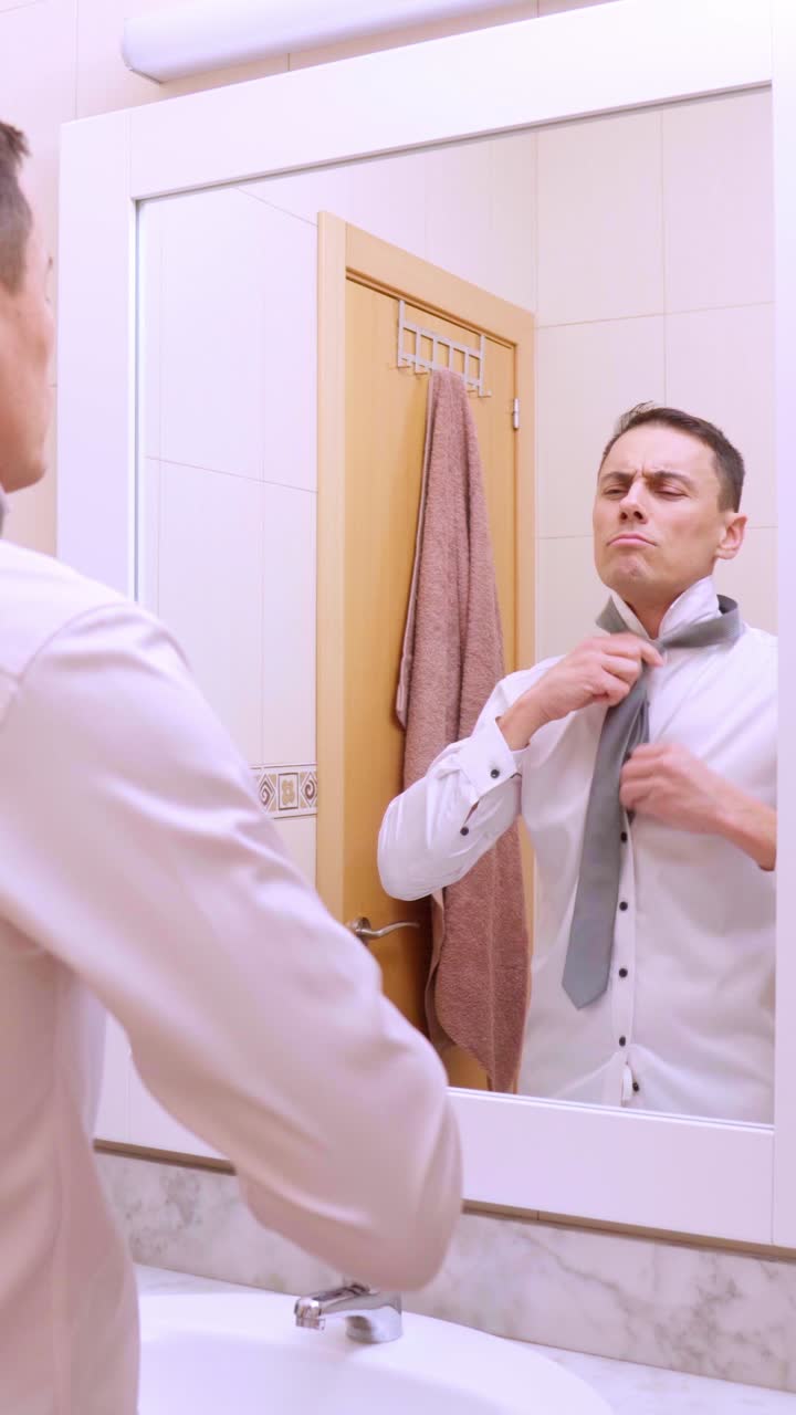 Elegant businessman getting ready in bathroom mirror
