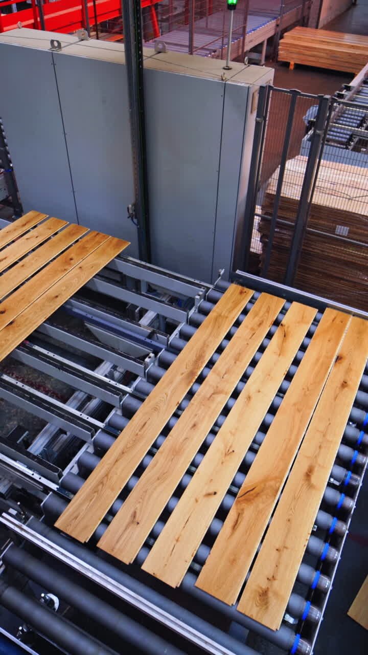 Wooden factory indoors. Production line with laminated panels. Workers inside the parquet plant. Laminate flooring concept. Vertical video