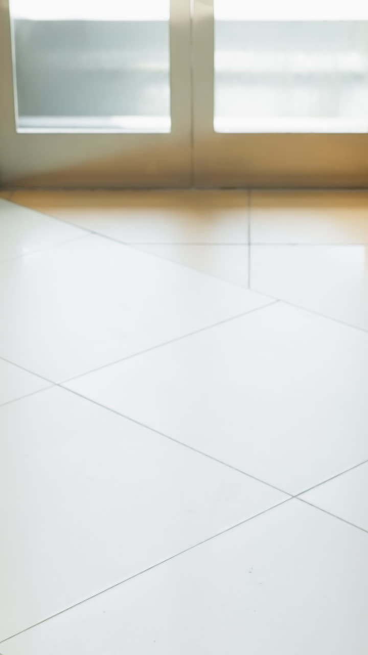 una vista detallada en primera persona tomada con una cámara de mano, capturando las mitades inferiores de varias personas de pie dentro de un ascensor. la imagen se centra en la diversidad de calzado y ropa