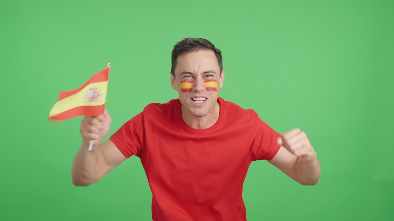 Passionate spanish supporter screaming and waving a national flag
