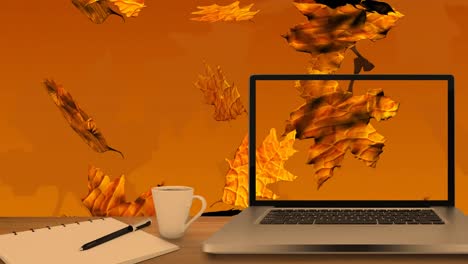 desktop computer and office equipment on a table against autumn maples leaves falling in background