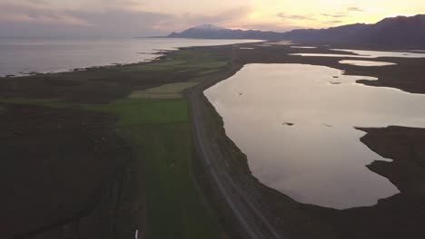 Aerial-Footage-of-Lake,-Ocean,-Mountains-and-Snaefells-Volcano-During-Cloudy-Summer-Sunset-In-Snaefellsness-Peninsula,-Iceland