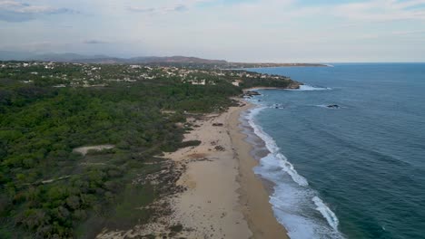 Playa-Bacocho,-It-has-fine,-soft-sand,-palm-trees,-warm,-blue-green-water-and-a-moderate-surf-although,-Oaxaca