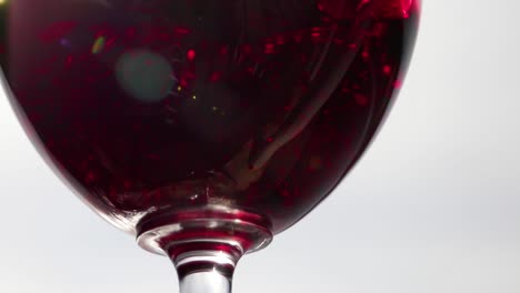 red wine pouring into empty wine glass