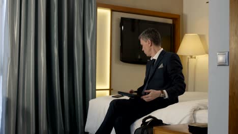 businessman leaving hotel room with suitcase