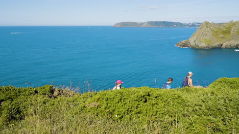 family hiking coastal view
