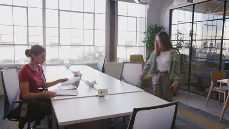 millennial multi-ethnic colleagues working in a busy open plan creative office, fast motion