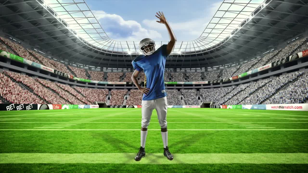 아메리칸  ⁇ 볼 선수 가 팔 을 들고 승리 하고 있다