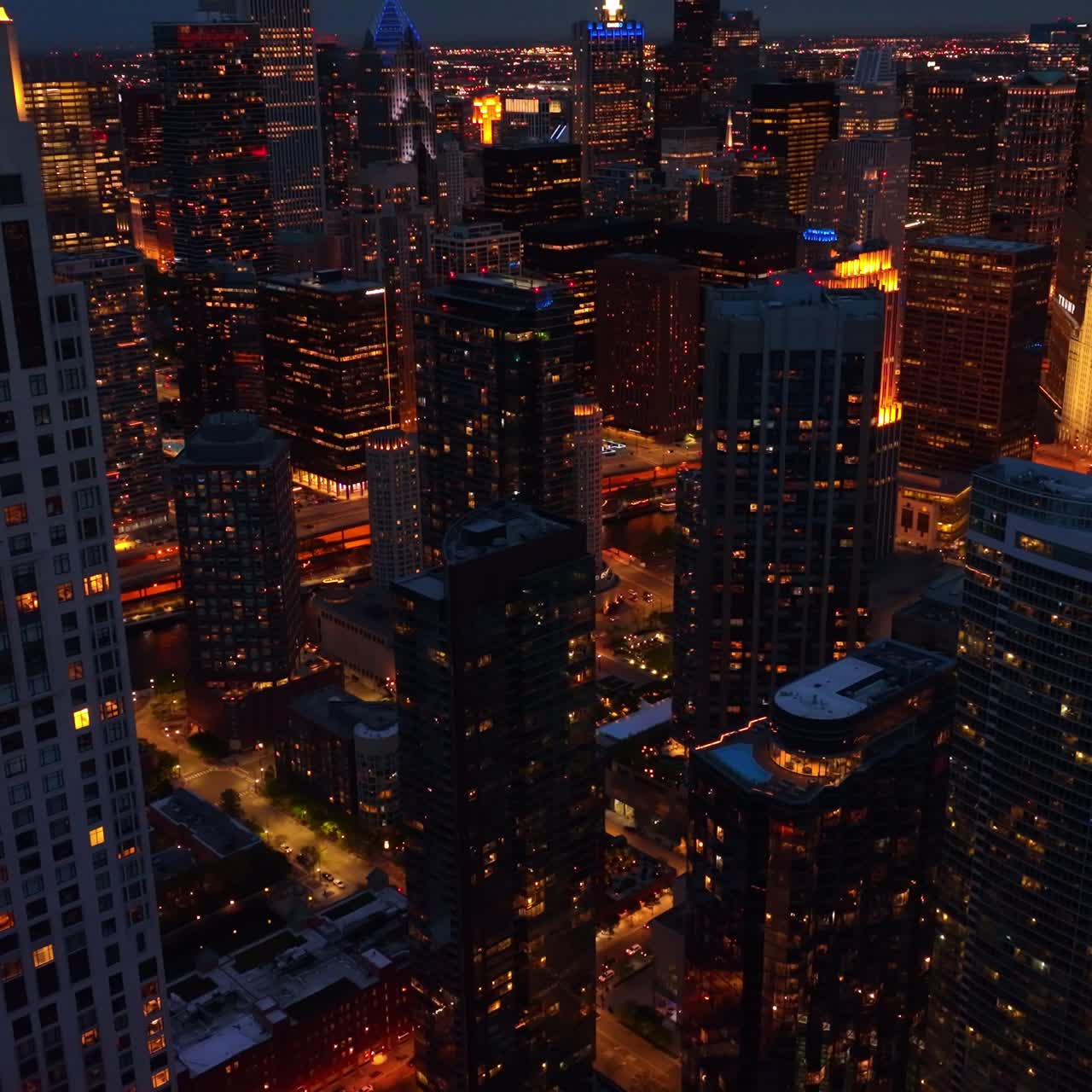 Contemporary architecture of stunning Chicago at night. Drone footage descending among beautiful skyscrapers