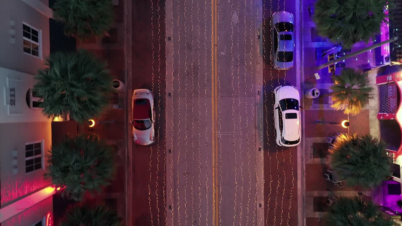 Aerial View of a Lit-Up Downtown Street at Night