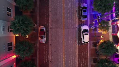 aerial view of a lit-up downtown street at night