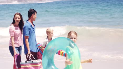 young family walking together with picnic stuff