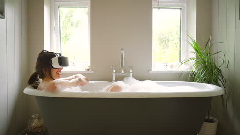 woman relaxing in a bathtub with vr headset