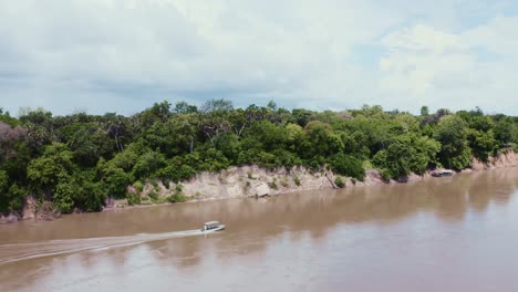 boat sailing in an open river in the jungle in tanzania