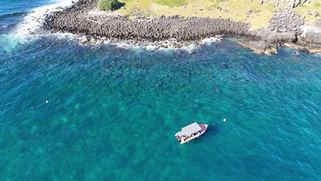 a boat navigates near fingal head's unique geology