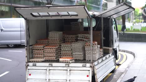 truck with doors open full of egg trays