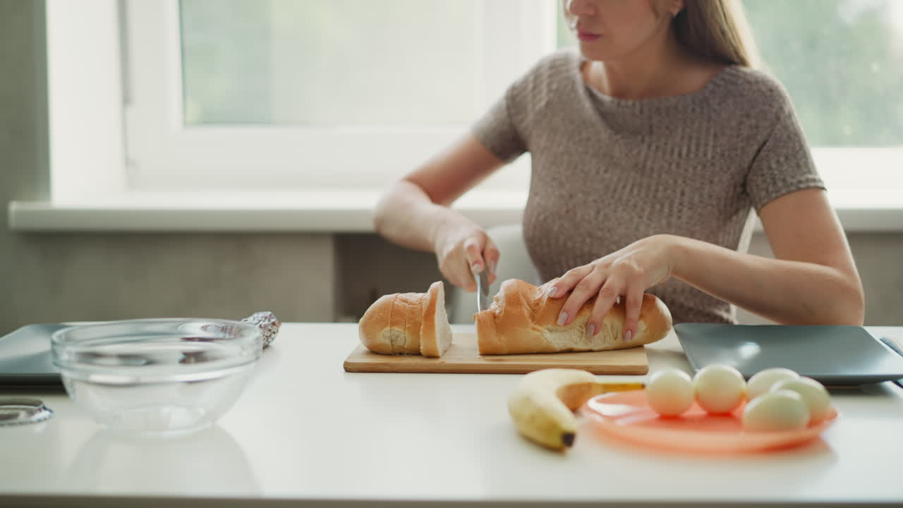 Woman Preparing a Sandwich in a Kitchen