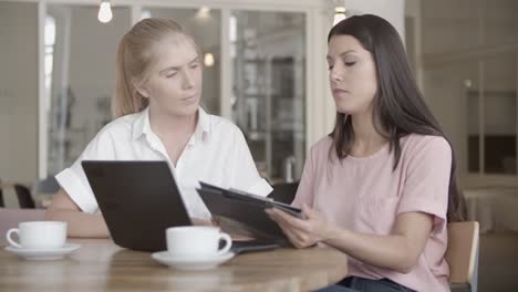 successful brunette manager signing contract and giving documents to her teammate