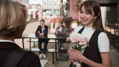 boy giving flowers to girl