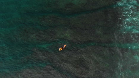 Surfer-paddling-in-an-amazing-clear-Bali-sea,-failing-to-surf-on-the-coming-white-water-wave