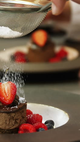 chefs putting finishing touch on desserts