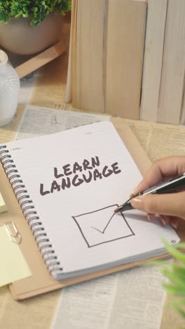 vertical video of ticking off learn language from checklist