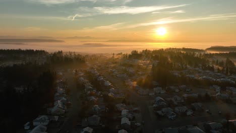 wide aerial view of houses in oak harbor, washington during a foggy sunrise