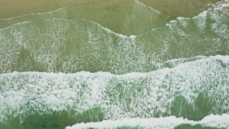aerial views of tropical waves rolling into the shore