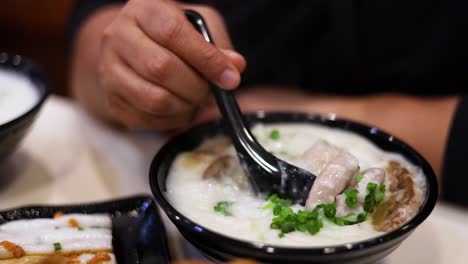 savoring a bowl of rice porridge